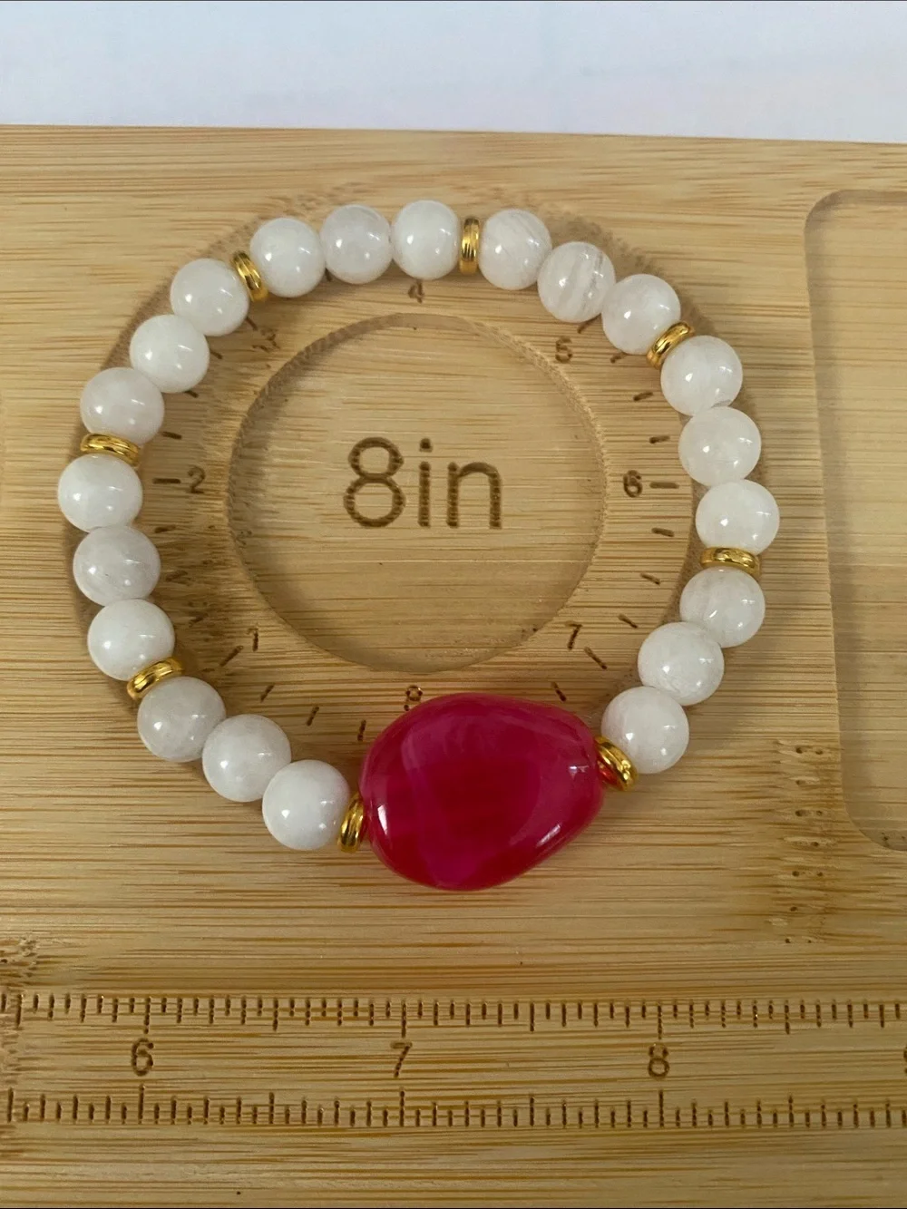 White Beaded Bracelet with Pink Focal Stone and Gold Accents